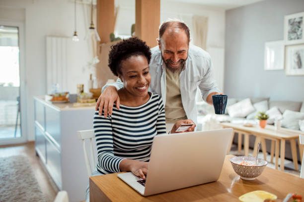 istock Mid adult couple online shopping while having breakfast 1450018521