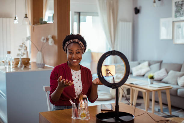 istock Young woman recording a make-up tutorial on her phone 1450018817