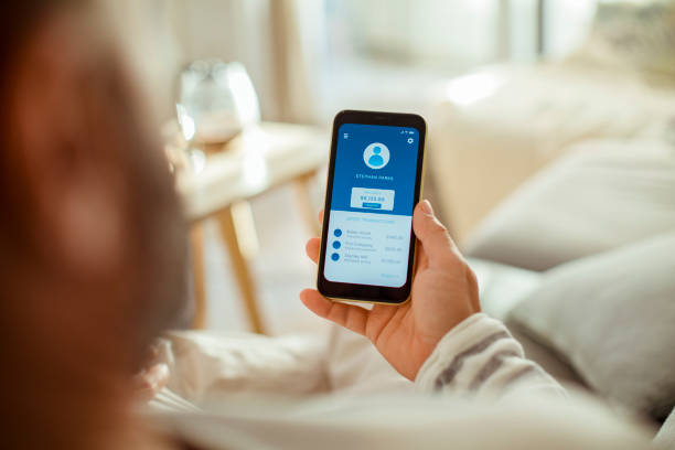 istock Mid adult man using a banking app on his phone 1450019445