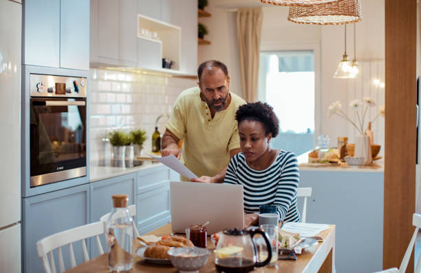 istock Mid adult couple going over their home finances while having breakfast 1450019551