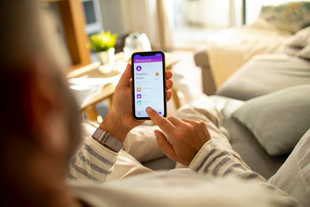 istock Mid adult man using a banking app on his phone 1450019872