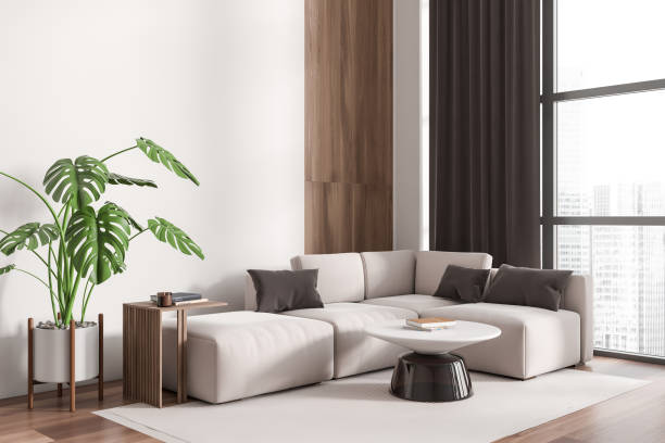 istock Corner view on bright living room interior with sofa, window 1450023387