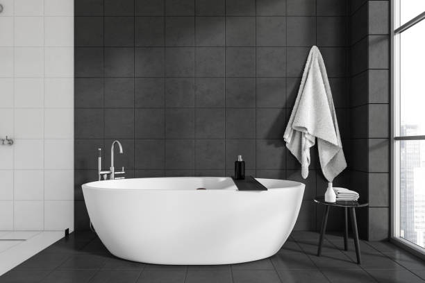 istock Modern bathroom interior with bathtub near window. Copy space 1450023399