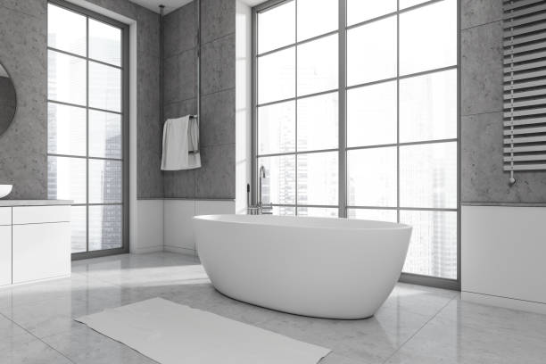 istock Modern bathroom interior with bathtub in the corner and panoramic window 1450023624