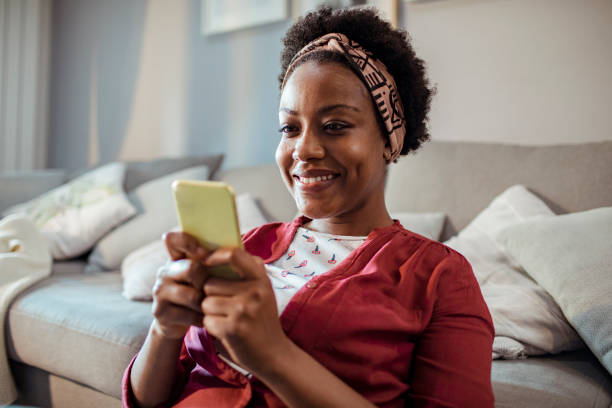 istock Young woman texting on her smart phone 1450024488