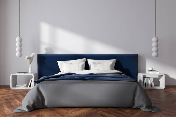 istock Front view on bright bedroom interior with bed, bedsides, pillows 1450024524