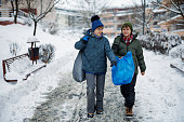 Teenage boys taking out the segregated garbage on winter day