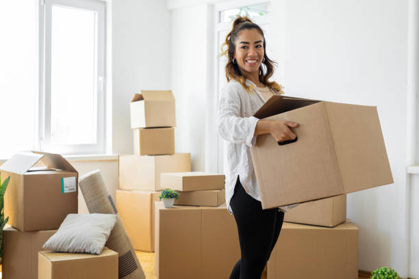 istock Woman carrying boxes into her new place 1450025694