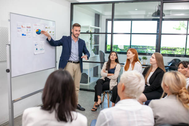 istock business team male and female colleagues talking at work share ideas with chart on board, Happy young presentation colleagues work together on board. 1450028733