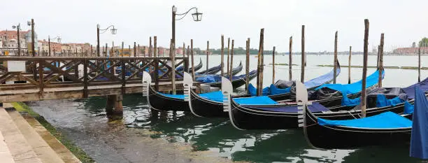 moored gondolas boats in the basin near the St.Mark Square in Venice in Northern Italy WITHOUT PEOPLE