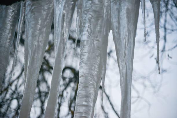 Icicles hanging from the roof against the sky