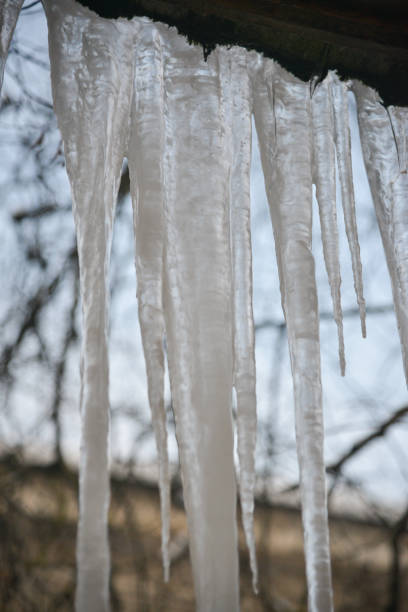 Icicles hanging from the roof against the sky