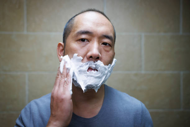Middle aged man prepares to shave