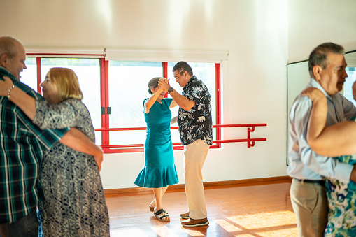 Mature couples dancing at a class in a dance studio