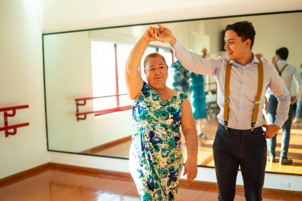 istock Dancing teacher teaching senior woman at a class in a dance studio 1450033871