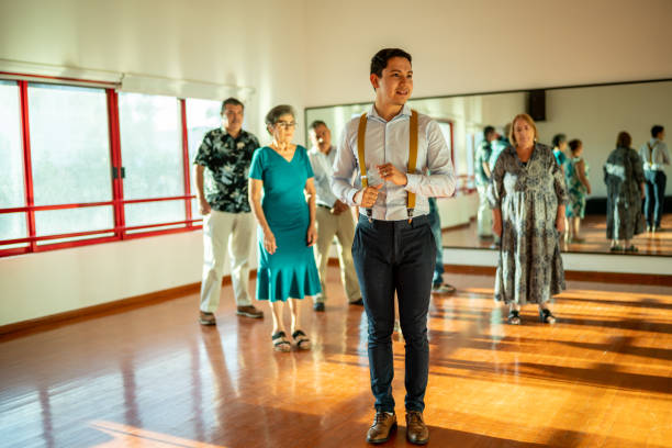 istock Young dancing instructor giving a class to a group of mature students at a dancing studio 1450034722