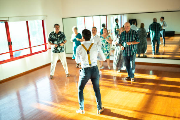 istock Dancing teacher with senior couple at a dancing class 1450035330