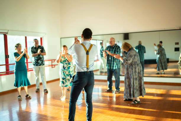 istock Dancing teacher with senior couple at a dancing class 1450035359