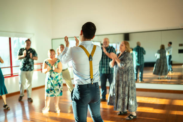 istock Dancing teacher with senior couple at a dancing class 1450035360