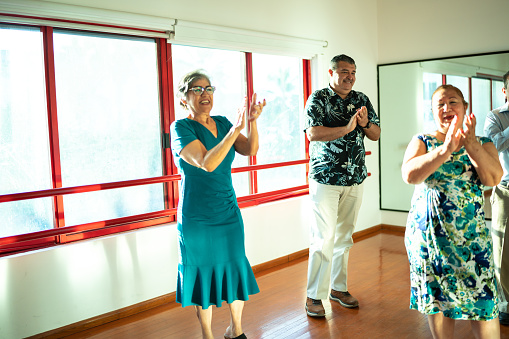 Mature students clapping at a dance studio