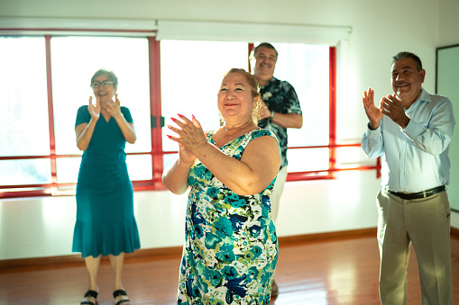 Mature students clapping at a dance studio