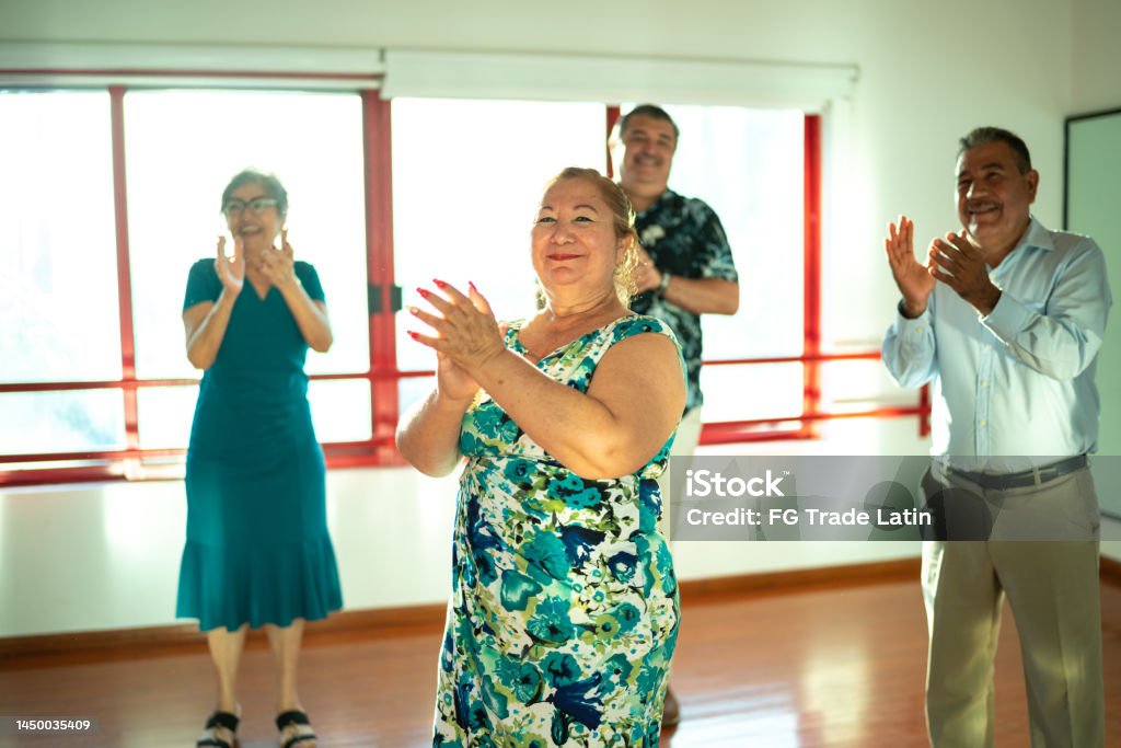 Mature students clapping at a dance studio 55-59 Years Stock Photo
