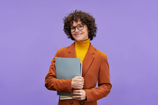 istock Young successful teacher in formalwear holding documents in isolation 1450035598
