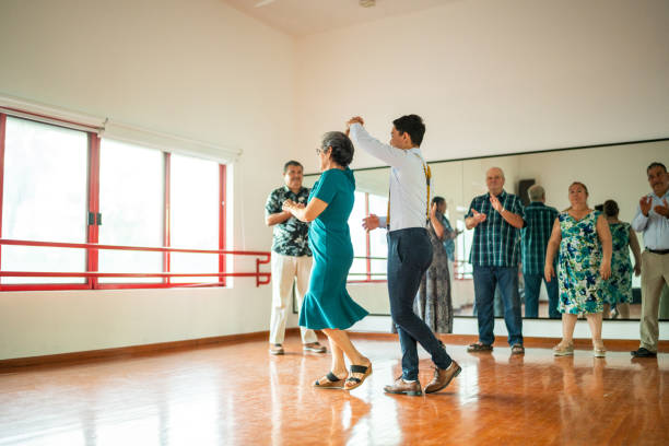 istock Senior woman dancing with dancing instructor at a dance studio 1450035930