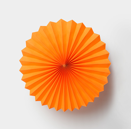Orange paper fan isolated on white background
