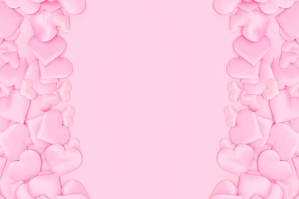 istock Border frame made of textile hearts confetti on a pink background. 1450037594