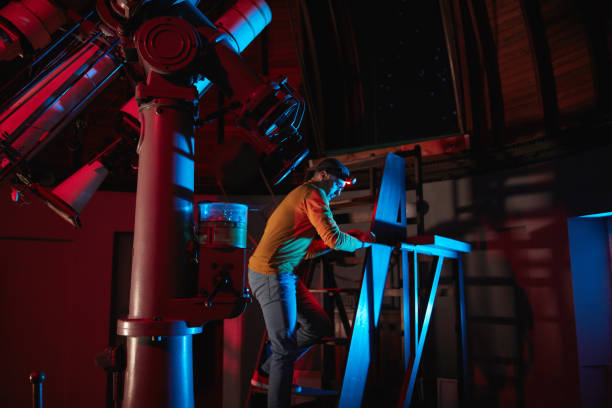 istock Astronomer with a big astronomical telescope in observatory doing science research of space and celestial objects. 1450037658