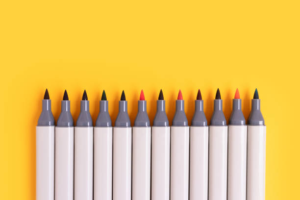istock Row of felt tip pens on a yellow background. 1450038272