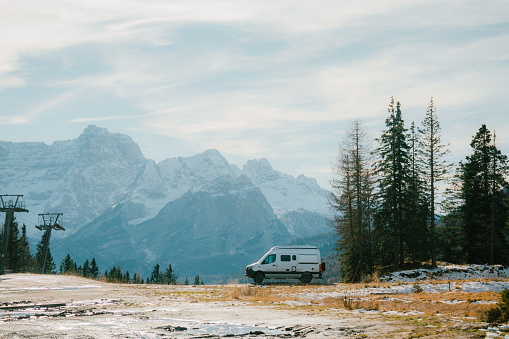 Scenic view of camper van  parked in national park in Dolomites in winter