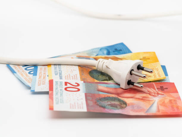 istock Swiss banknotes and a power plug 1450050600