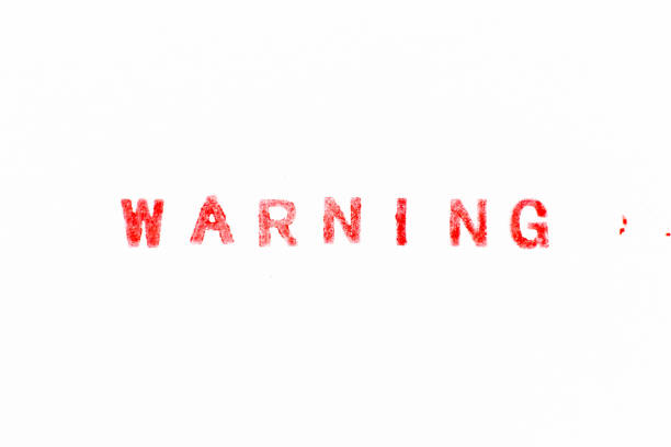 istock Red color ink rubber stamp in word warning on white paper background 1450050711