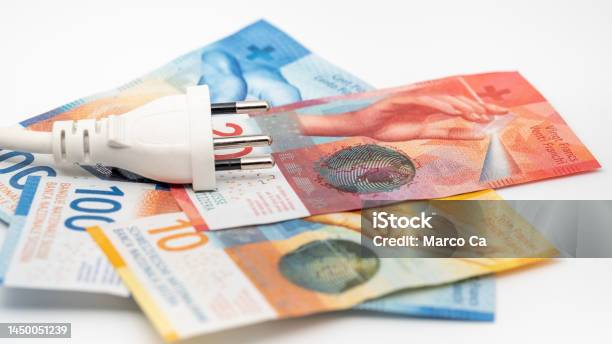 A Power Plug On Some Swiss Franc Banknotes Stock Photo - Download Image Now - Currency, Swiss Currency, Savings