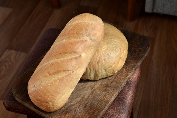 istock Bread and loaf of wheat flour, top view. 1450052055