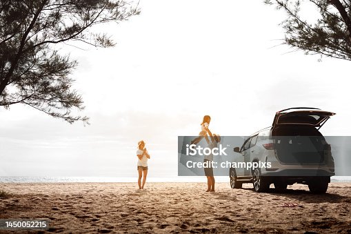 istock Happy Family with car travel road trip. summer vacation in car in the sunset, Dad, mom and daughter happy traveling enjoy together driving in holidays, people lifestyle ride by automobile. 1450052215