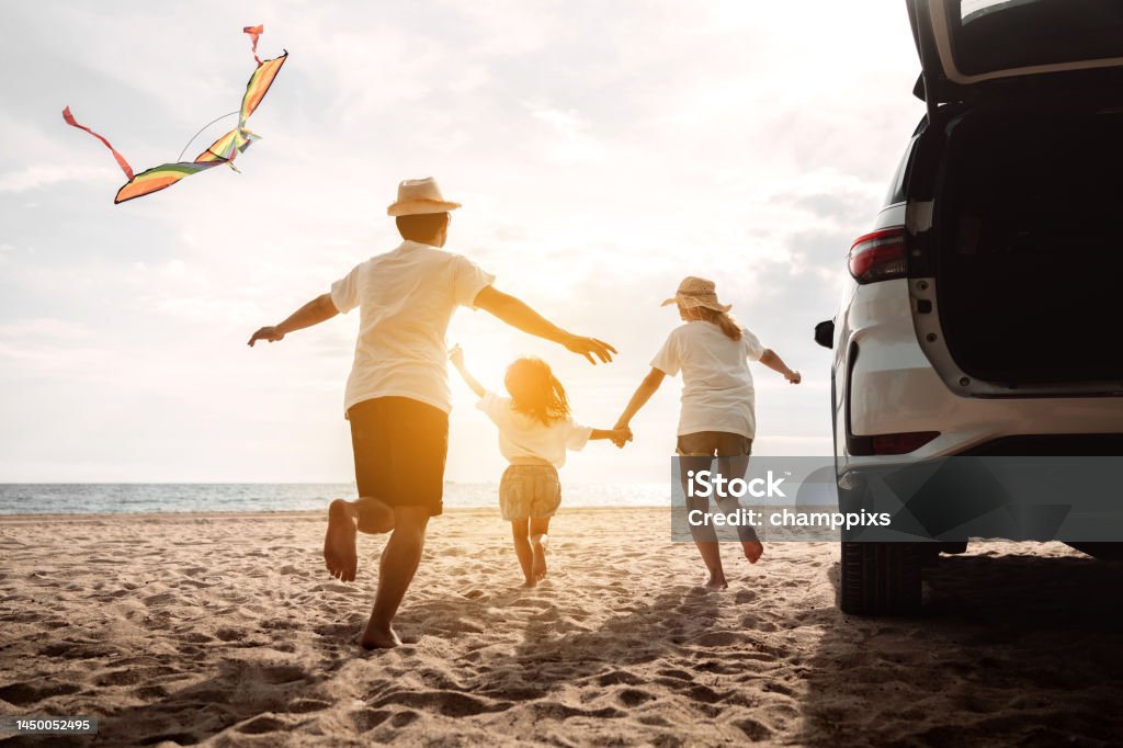 Happy Family with car travel road trip. summer vacation in car in the sunset, Dad, mom and daughter happy traveling enjoy together driving in holidays, people lifestyle ride by automobile. Family Stock Photo