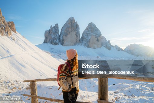 istock Woman hiking  on the background of Tre Cime di Lavaredo in winter 1450054416