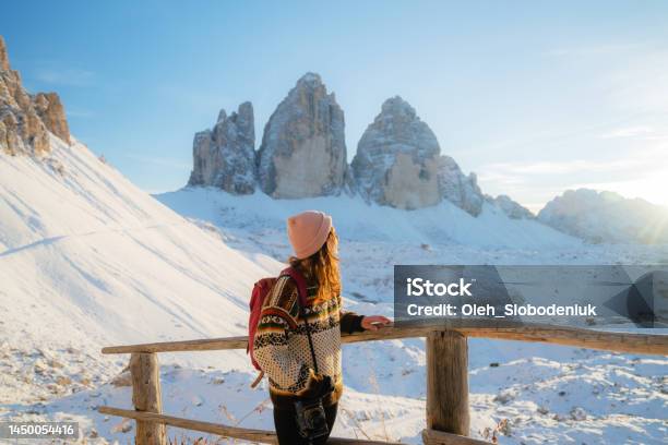 Woman Hiking On The Background Of Tre Cime Di Lavaredo In Winter Stock Photo - Download Image Now