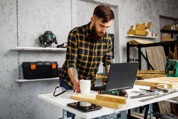 istock Craft person using laptop in carpenter's workshop 1450055458