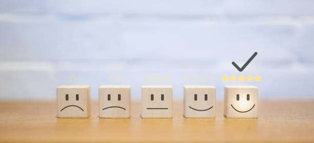istock Chooses a smile face on wood block cube. Satisfaction survey. Questionnaire best excellent business services rating customer experience. five Star good comparison. 1450058655
