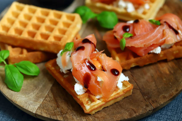 istock Delicious salmon sandwiches with white cheese on waffles. 1450058686