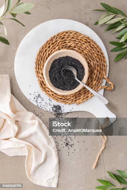 Black Sesame Seeds Or Gergelim In Ceramic Bowl With Spoon In Kitchen Countertop For Healthy Food And Diet Concepts Top View Stock Photo - Download Image Now