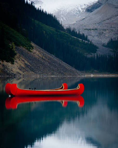 istock Red Canoes on Mountain Lake 1450063199