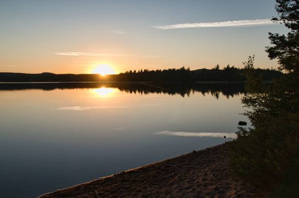 istock Beautiful bright sunrise over the lake shore 1450063655