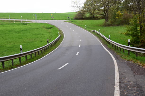 istock country road curve in green landscape 1450065730