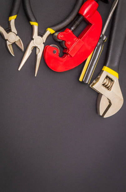 istock Set of tools on black background prepared by the master before repair or construction 1450066252