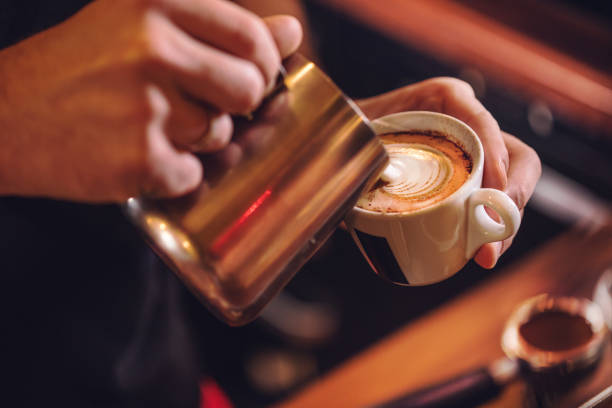 istock Man preparing coffee at table in cafe 1450067291